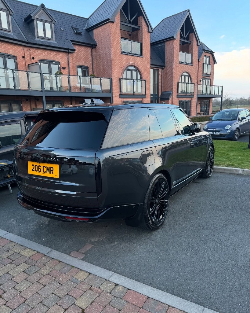 Black Range Rover detailed to a deep gloss, rear three-quarter