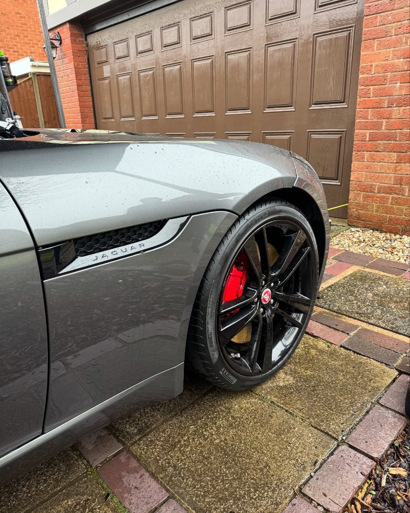Grey Jaguar F-Type wheel with red calipers, cleaned and dressed