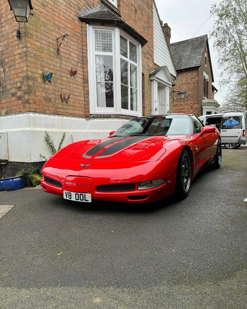 Red C5 Corvette front three-quarter with a deep shine