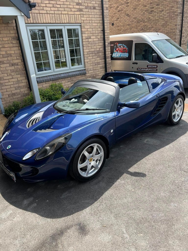 Blue Lotus Elise detailed beside the HERF Valeting van