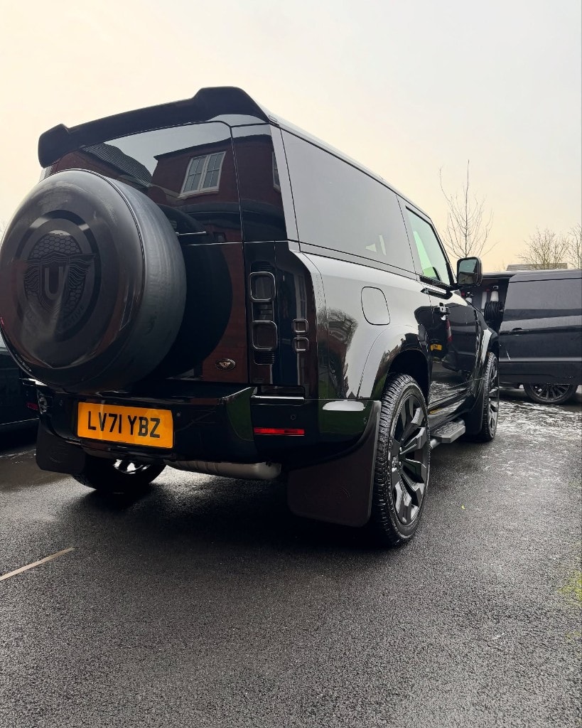 Black Land Rover Defender detailed rear three-quarter