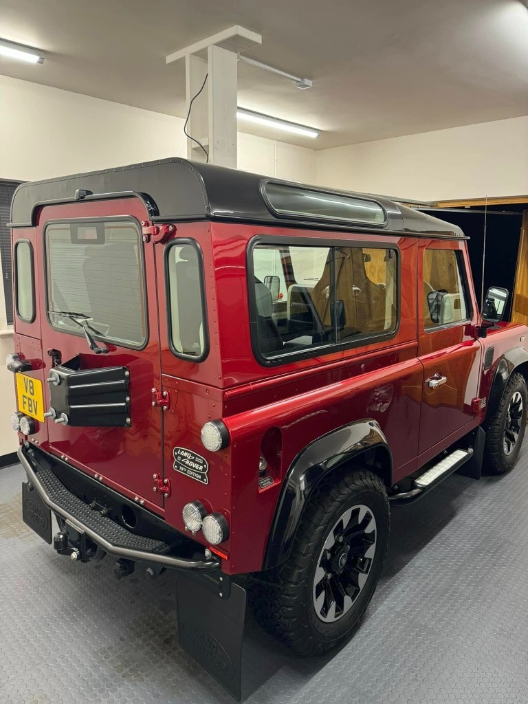 Red Land Rover Defender 90 detailed indoors